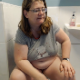 An older, pudgy, British woman with glasses strains to take a shit while sitting on a toilet. She complains of the painful constipation. Nice plop sounds are heard. Presented in 720P HD video. Over 7 minutes long.